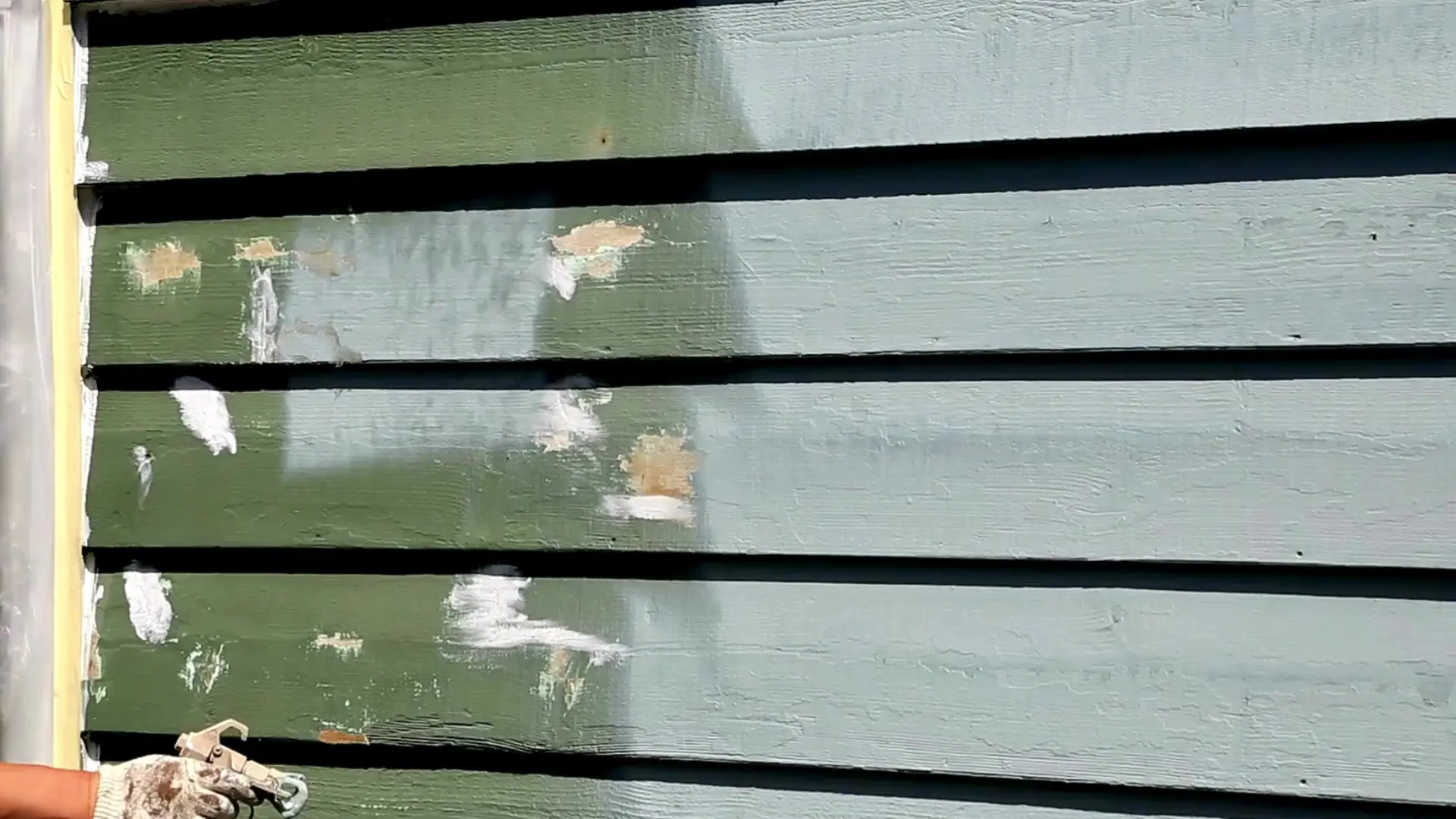 Exterior siding being professionally painted