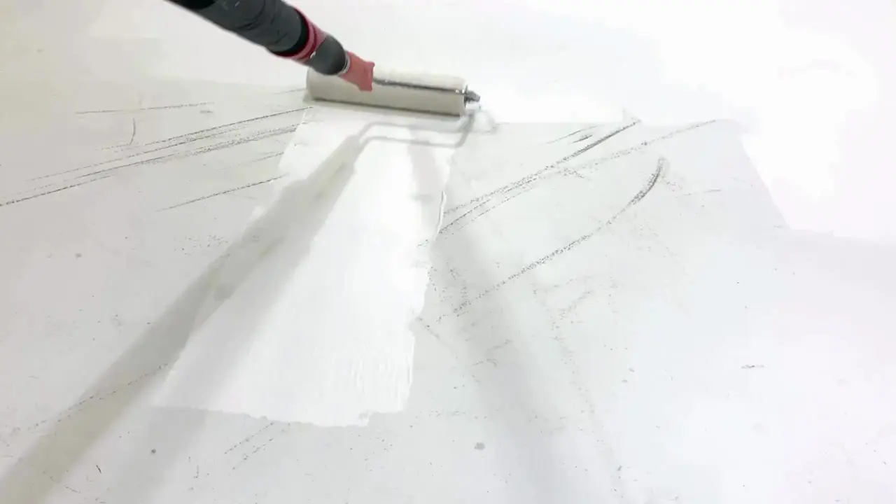 White paint being applied with a roller